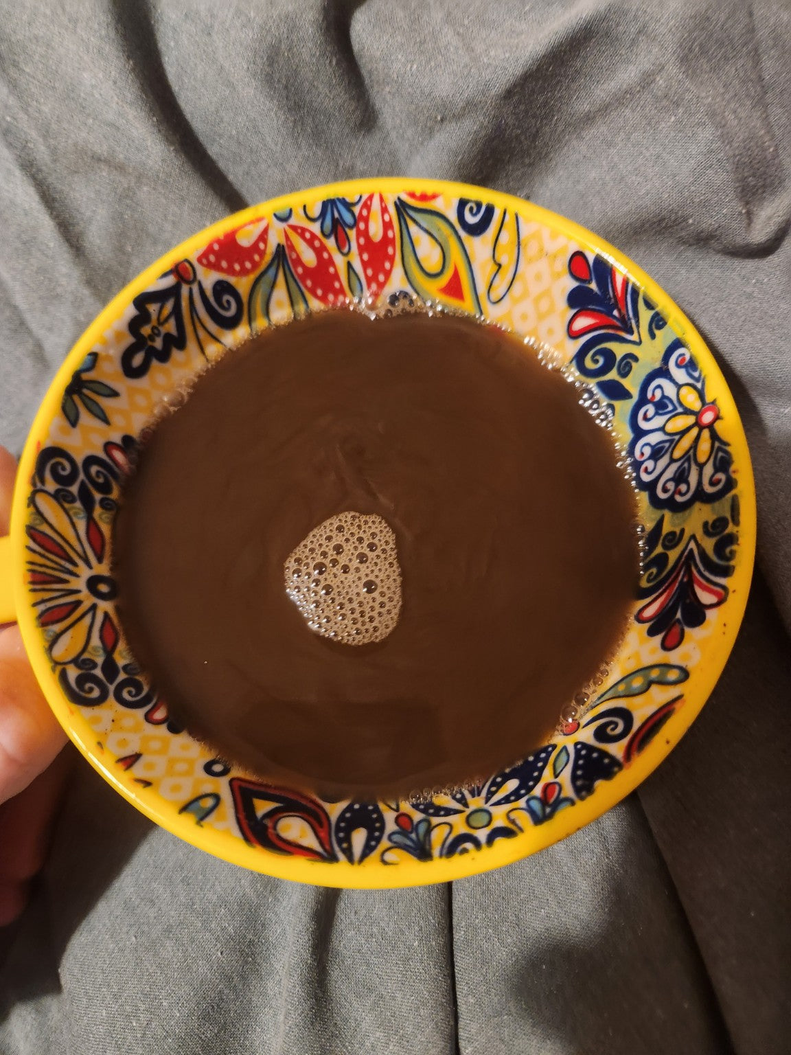 A real cup of cacao in a patterned yellow ceramic mug