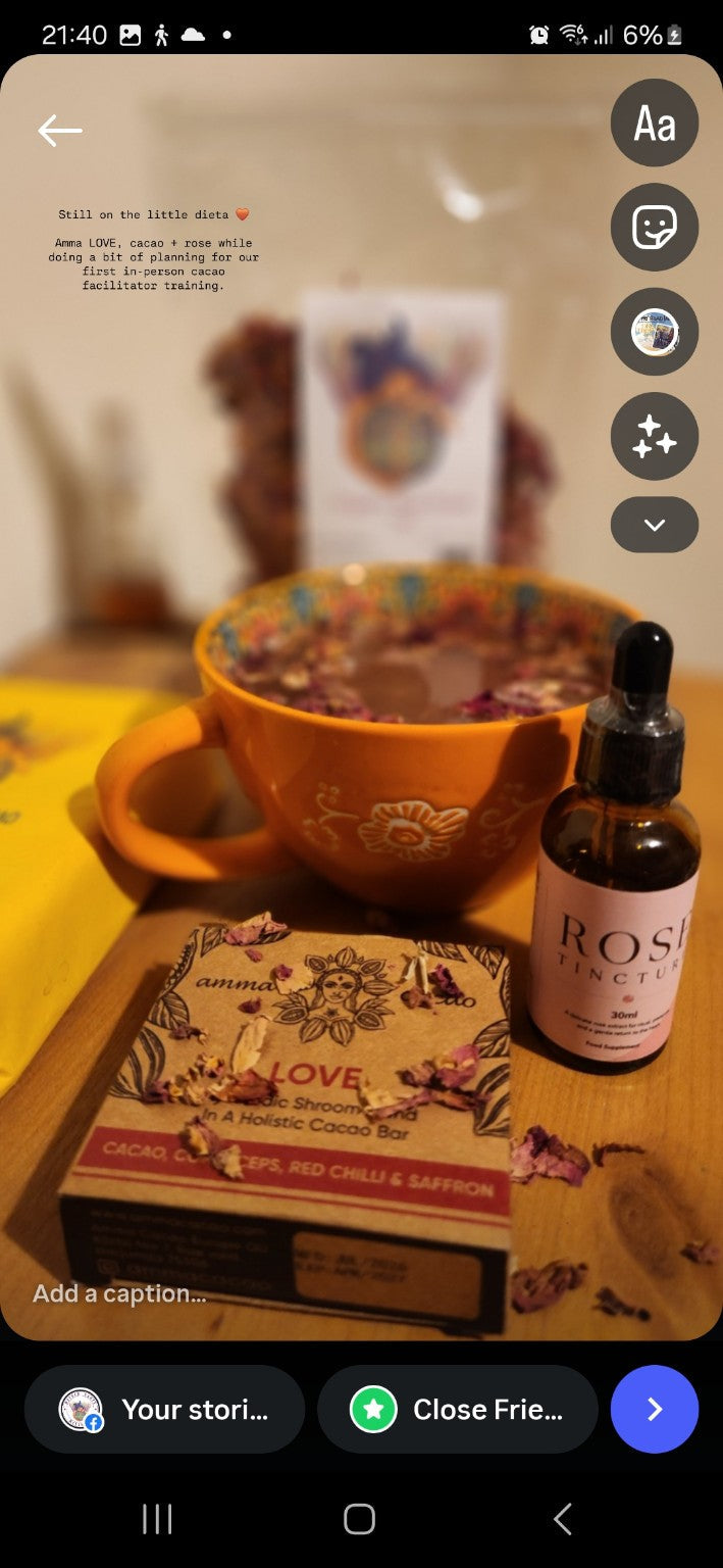 Amma LOVE cacao bar beside a cup of cacao and rose products from Mother Earth